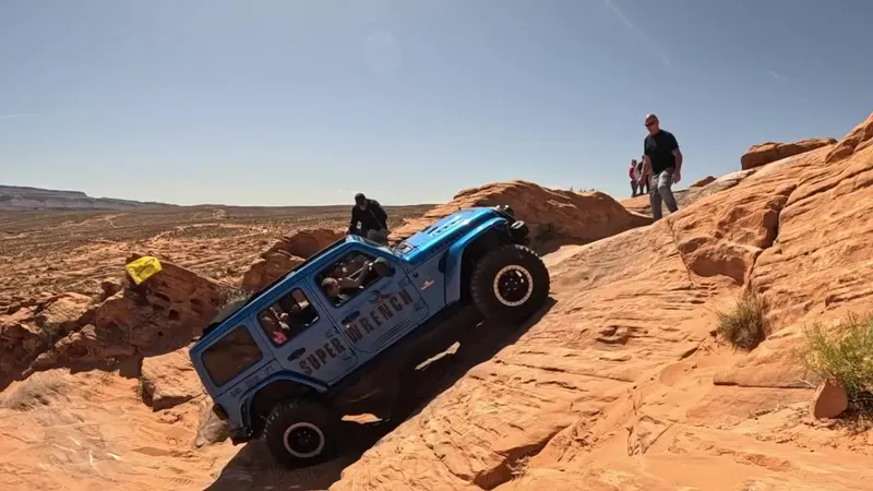 Blue Super Wrench Jeep approaching a rock climb