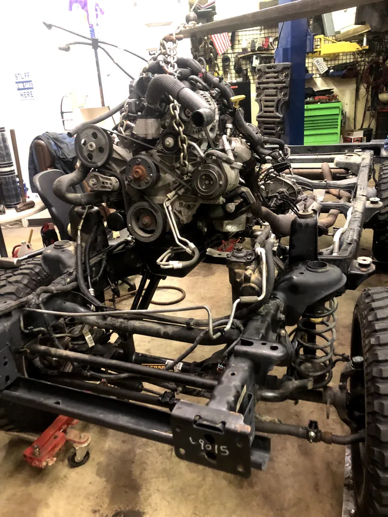 Engine and front chassis exposed during workshop repairs