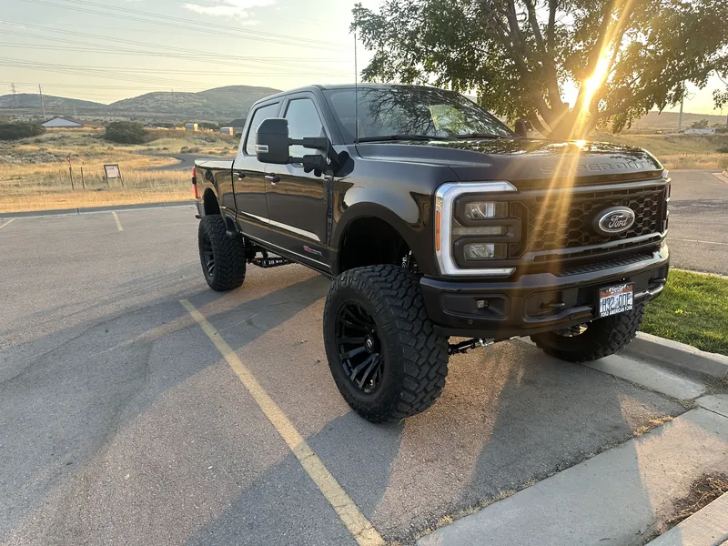 Black Ford truck photographed at sunset