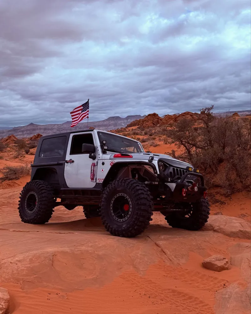 White Jeep on a red-rock ledge